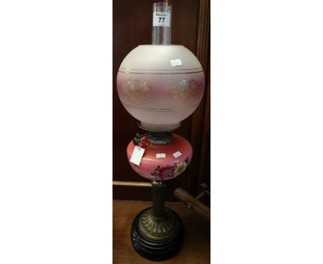 Early 20th Century brass double burner oil lamp with painted ceramic reservoir, brass pedestal and ceramic base, frosted glas