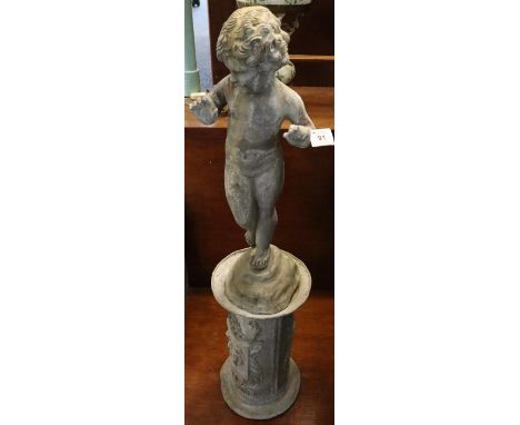 Cast lead garden figure in the form of a dancing putti with associated pedestal base having heraldic decoration. 93cm high ap