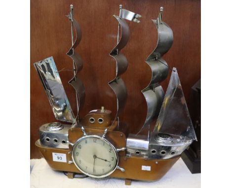 Mid Century electric mantel clock in the form of a three masted galleon with plated metal mounts and ship's wheel bezel to th