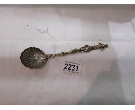 A decorative spoon with figure finial.