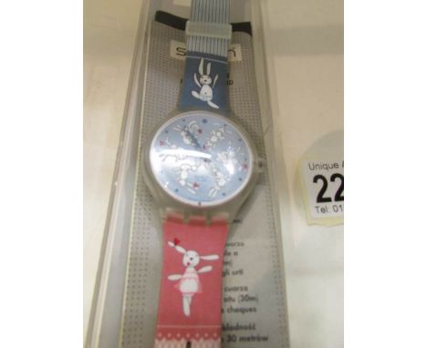 A Gentleman's Swatch wrist watch depicting rabbits.