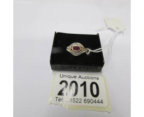 An 18ct gold ruby and diamond ring, size I half.