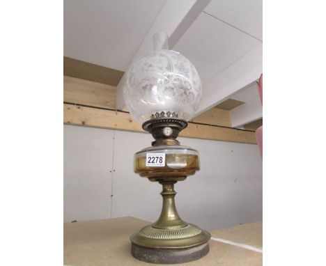 A Victorian oil lamp complete with chimney and original acid etched shade.