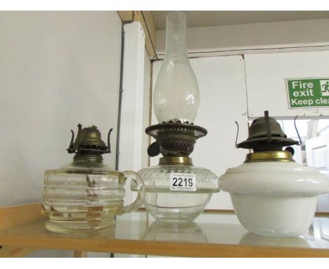 2 oil lamp fonts (one with chimney) and a hand held oil lamp.