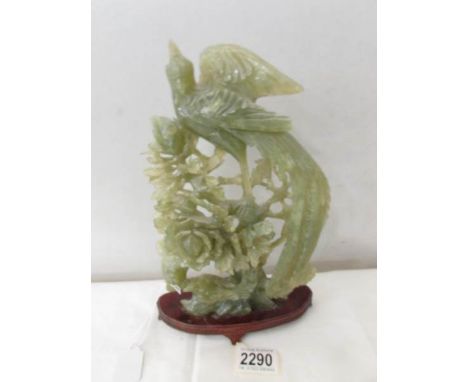 A piece of carved jade depicting pheasant and other birds.