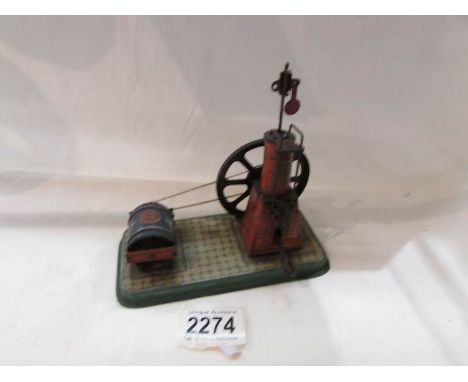 An early 20th century German tin plate clock work steam engine.