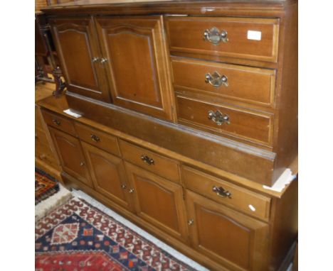 A modern mahogany Stag sideboard, the plain top above four drawers and four cupboards, raised on bracket feet, 176 cm wide x 