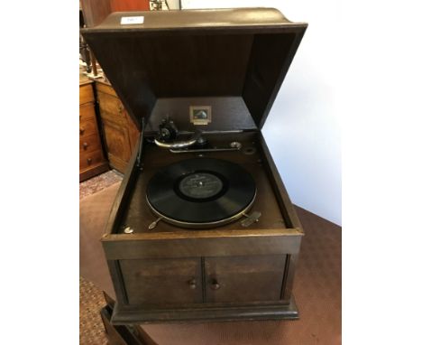 An HMV oak-cased table top gramophone with rising caddy top over two sound doors, 47.5cm x 39cm x approx 33cm H