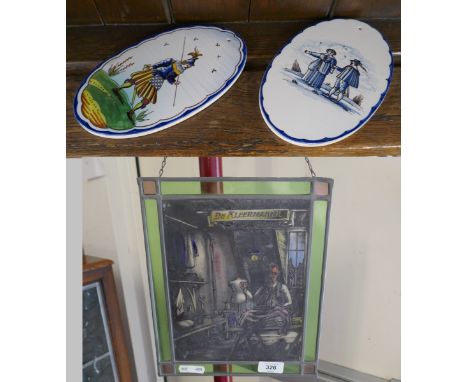 Dutch stained glass panel together with pair or ceramic wall hangings 