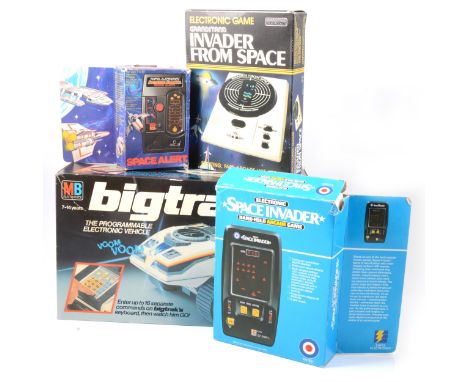 Four electronic games and toys; MB big-trak, the programmable electronic vehicle; Grandstand Invader from Space; Entex Space 