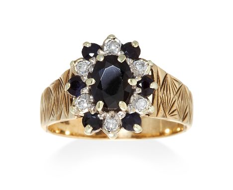 A SAPPHIRE AND DIAMOND CLUSTER RING in 9ct yellow gold, comprising of oval cut sapphire in a cluster of round cut diamonds an