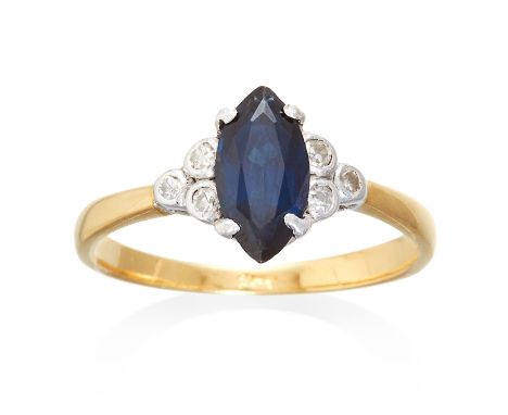 A SAPPHIRE AND DIAMOND RING in yellow gold, set with a marquise cut sapphire between dix round cut diamonds, marked indistinc