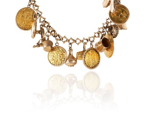 A GOLD CHARM BRACELET in 9ct and 18ct gold, comprising of fifteen charms including animals, cup, shoes, etc., 18ct, 61.5g.