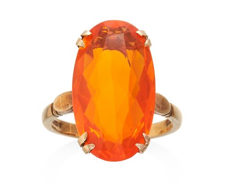 A FIRE OPAL DRESS RING in 9ct yellow gold, jewelled with an oval cut fire opal, full British hallmarks, size O / 7.5, 5.4g.