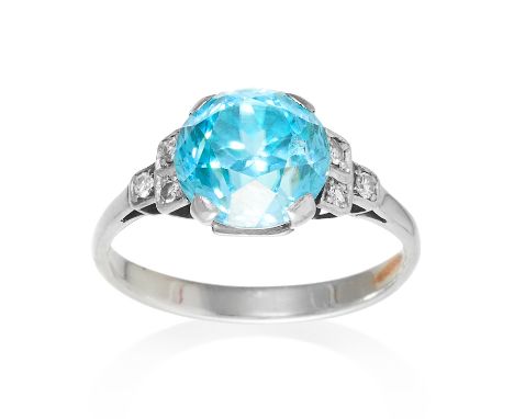 AN ART DECO BLUE ZIRCON AND DIAMOND RING in white gold or platinum, set with a round cut blue zircon with six old cut diamond