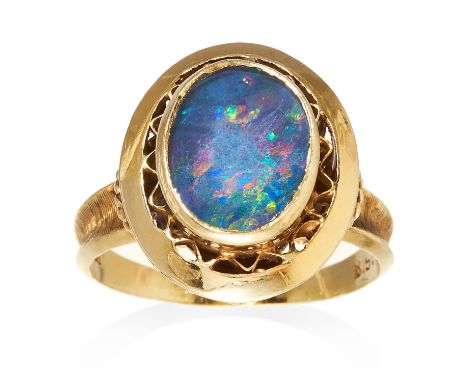 A BLACK OPAL RING in 18ct yellow gold, set with a central cabochon black opal, stamped 18K, size N / 6.5, 4.75g.