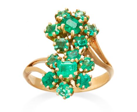 AN EMERALD TOI ET MOI RING in yellow gold, comprising of two floral clusters of emerald cut emeralds in toi et moi design, un