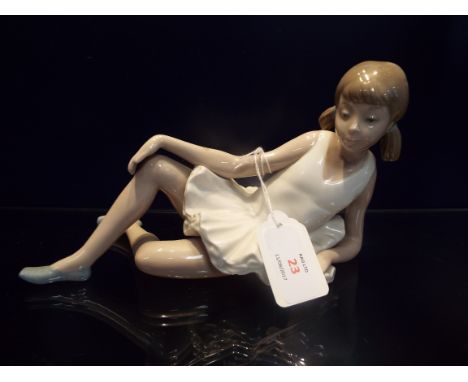 A Nao ballerina in reclining position, marks to base 