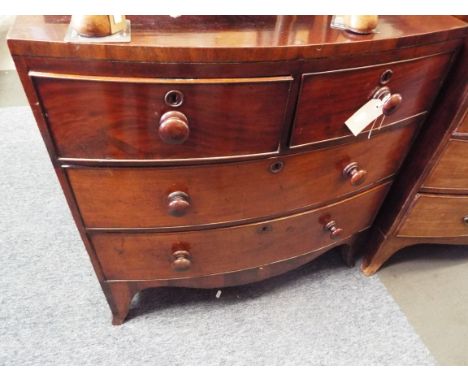 A mid-19thC mahogany and ebony strung bow-front chest of two short over two long cock-beaded drawers each with turned bun han