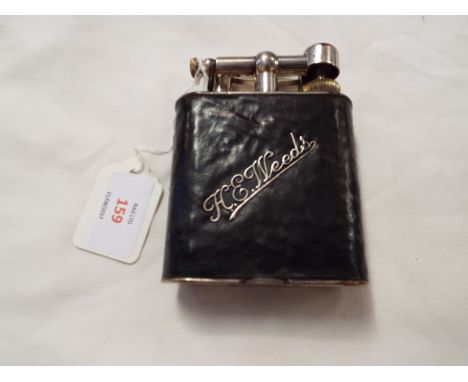 A large leather bound silver plated Dunhill table lighter inscribed in relief 'H.E. Weeds', patent no.143752 and registration