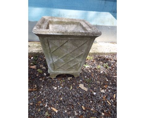 A square section stone planter in a lattice work design 