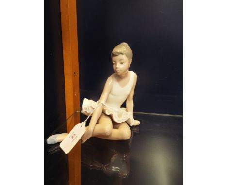 A Nao ballerina in seated position, marks to base 