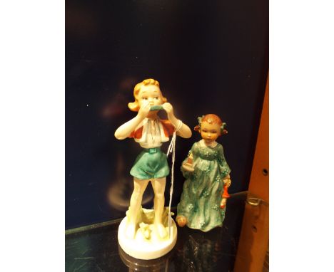 A Goebel figure of a girl with chamberstick and another of a girl with harmonica