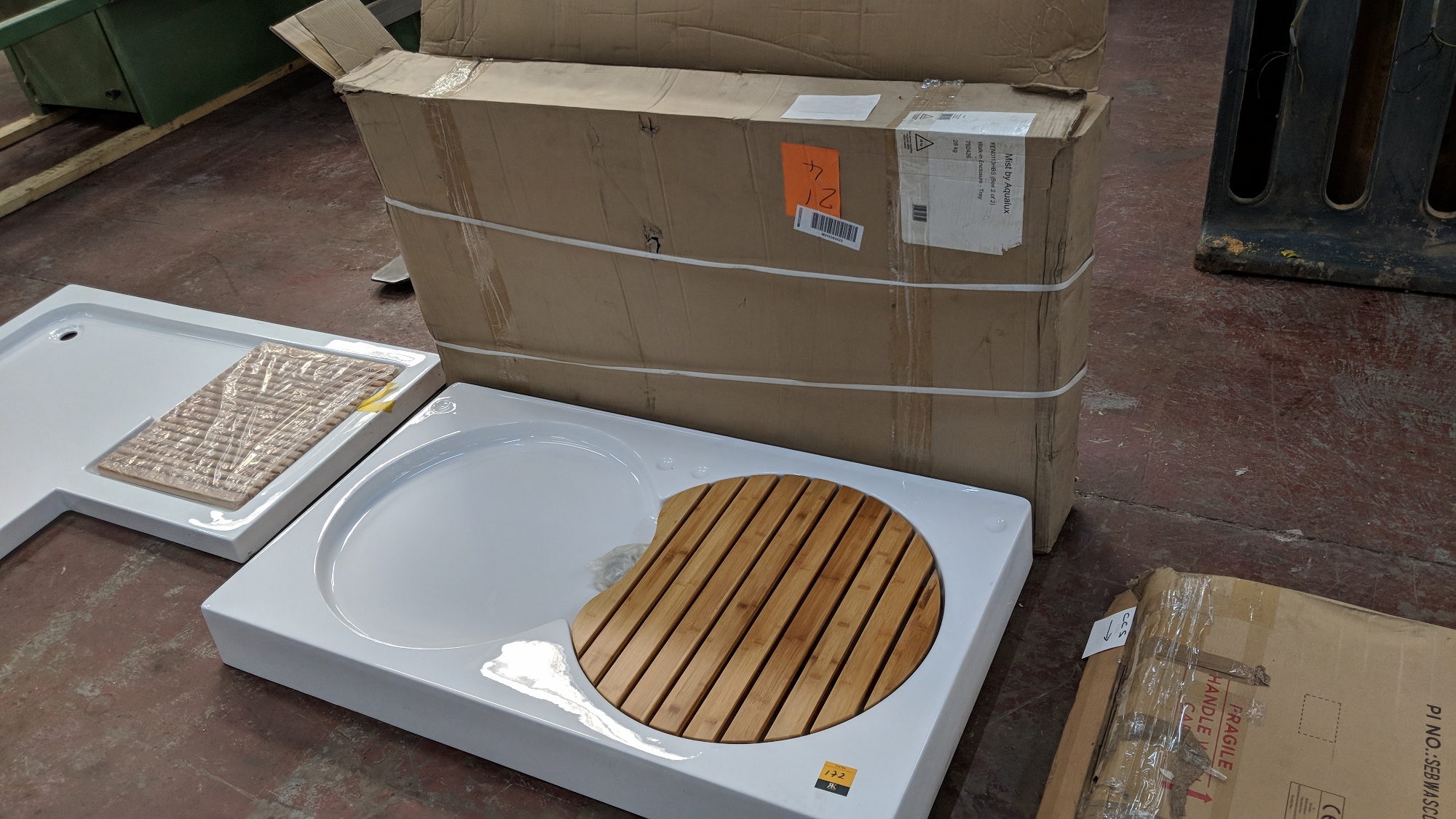 Large white shower tray with wooden slatted circular removable board