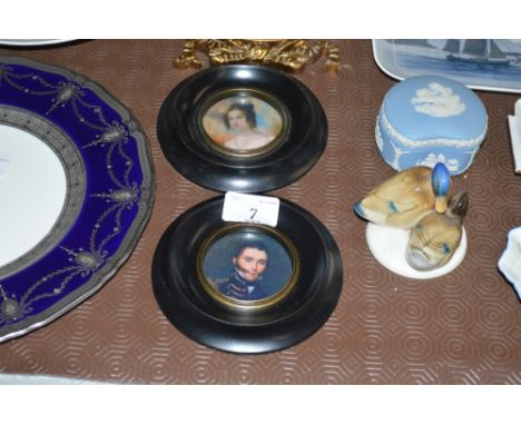 A pair of miniature portrait prints each contained in ebonised circular frames