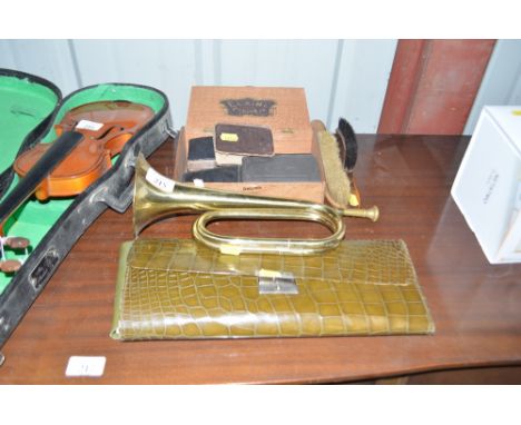 A brass bugle; a cigarette box containing small books; a clothes brush; a quantity of ladies gloves etc.