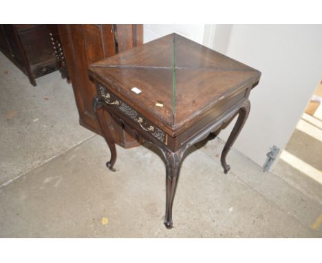 An Edwardian mahogany envelope card table, fitted single drawer