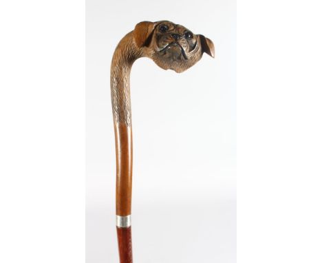 A WALKING STICK WITH DOG HEAD HANDLE.