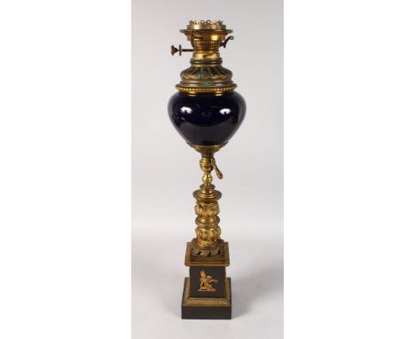 A TALL 19TH CENTURY FRENCH BLUE PORCELAIN AND GILT METAL OIL LAMP on a pedestal base. 28ins high.