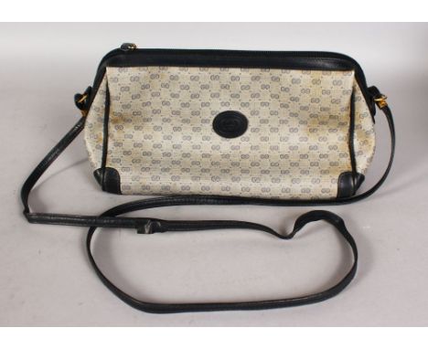 A VINTAGE 1980'S GUCCI NAVY AND GREY MONOGRAM GG SHOULDER BAG.