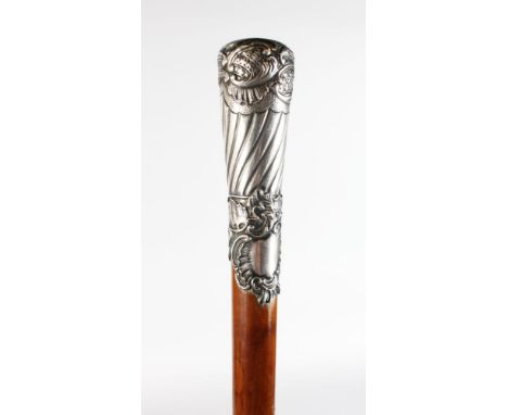 A WALKING STICK with carved SILVER HANDLE.