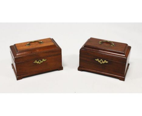 A NEAR PAIR OF GEORGE III MAHOGANY TEA CADDIES, with brass handles and escutcheons, lift up tops, on bracket feet. 9ins wide.