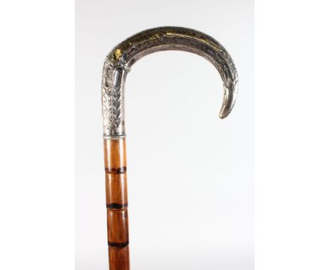 A WALKING STICK with carved SILVER HANDLE.