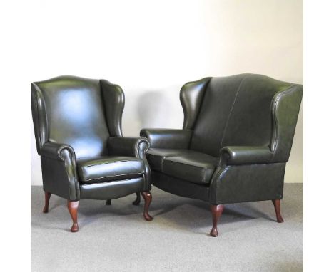 A Sherborne green leather upholstered wing armchair, together with a matching sofa, on cabriole legs, 132cm wide (2)