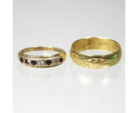 An 18 carat gold wedding band, with engraved decoration, 4g, size T, together with a gold, ruby and diamond half hoop eternit