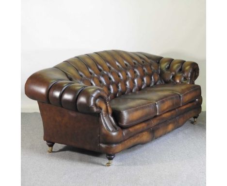 A Thomas Lloyd chocolate brown leather upholstered chesterfield three piece suite, comprising a button back sofa, with scroll