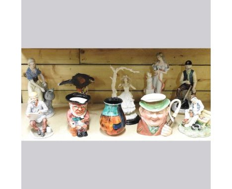 A Poole pottery vase, 16cm high, together with a collection of decorative figures and Toby jugs