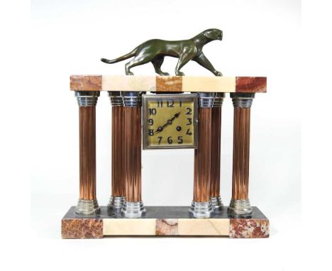 An Art Deco marble mantel clock, surmounted by a bronzed puma, 42cm wide