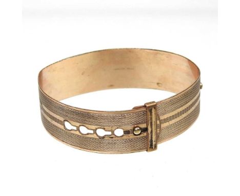 A rolled gold bangle, of collar design, with engine turned decoration, 16g, 6cm wide