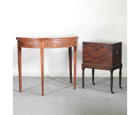 A George III D shaped folding card table, together with a Regency mahogany cellarette, on turned legs (2)