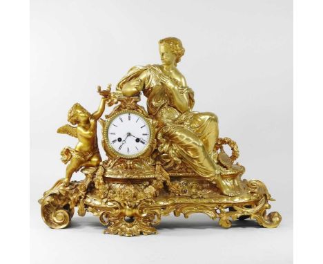 A large 19th century French ormolu figural mantel clock, the case surmounted by a reclining lady and a cherub, with festoons 
