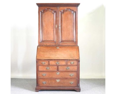 An 18th century oak and inlaid bureau cabinet, flanked by columns, on bracket feet104w x 58d x 210h cm