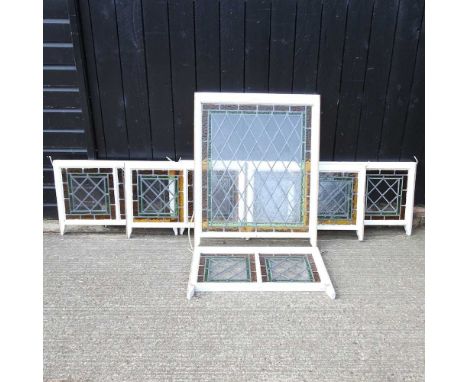 A stained glass sash window, 101 x 81cm, together with thirteen smaller matching windows (14)