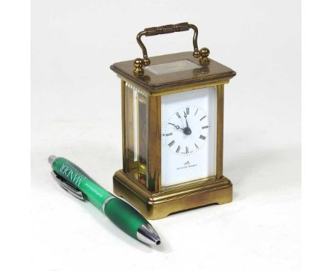 A brass cased miniature carriage clock, 20th century, the white enamel dial signed Matthew Norman, 10cm high overall