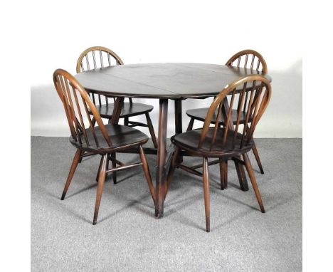 A 1970's Ercol dark elm drop leaf dining table, together with a set of four matching dining chairs (5)122w x 113d x 71h cm