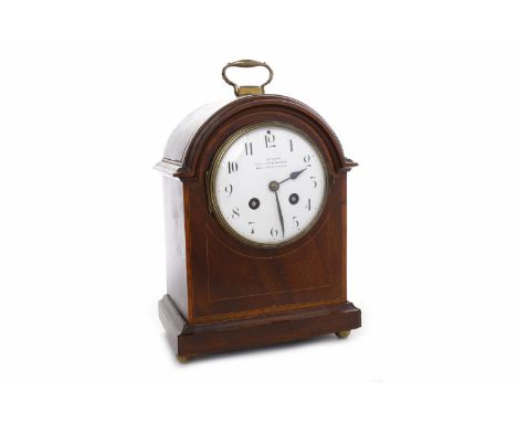 EDWARDIAN MAHOGANY BOXWOOD STRUNG BRACKET CLOCKthe enamelled dial with Roman numerals and steel hands, the dial reading 'Nort